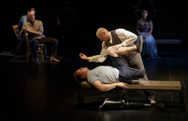 In the foreground, Keith A. Thompson and Paul Hurley, an amputee veteran, dance in "Healing Wars," choreographed by Liz Lerman at Arena Stage in Washington. Credit Matt Roth for The New York Times